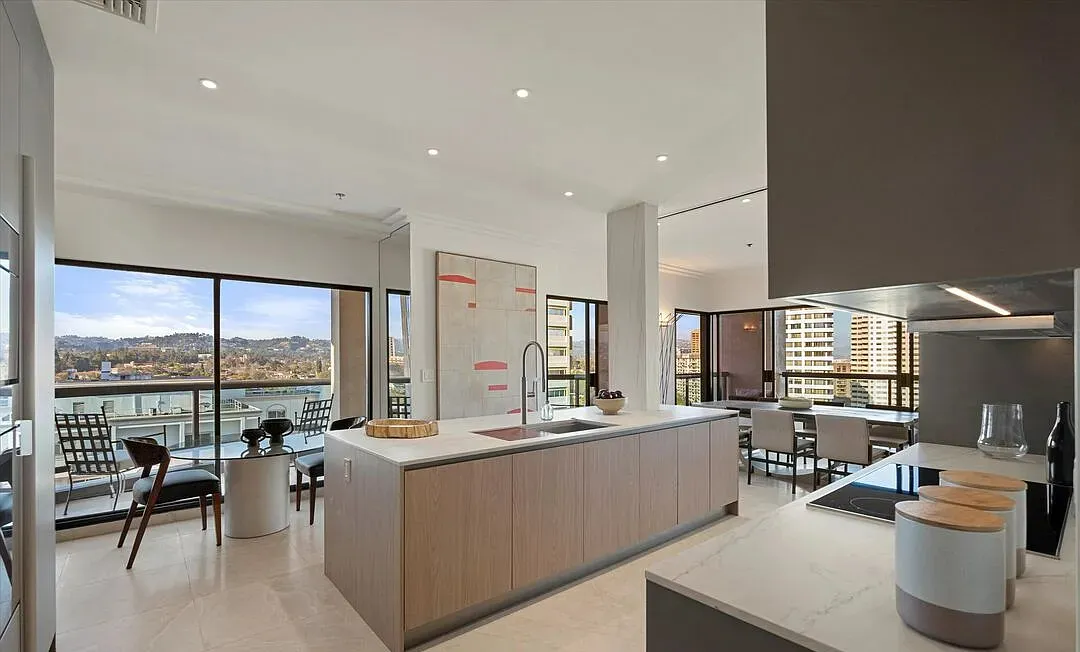 Kitchen island facing windows with hillside views