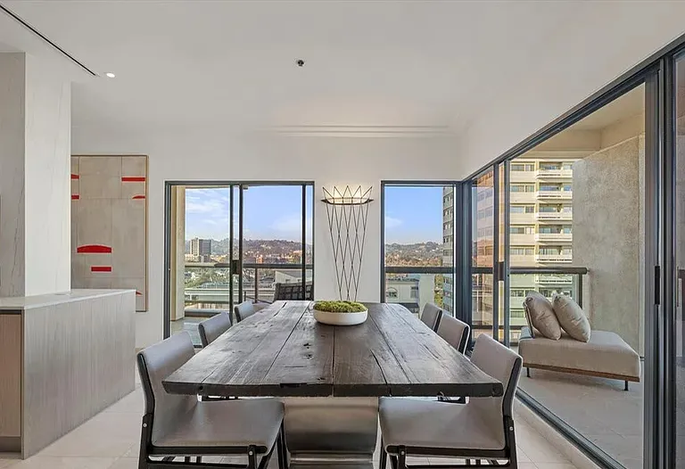 Dining room with a long wood table and corner windows