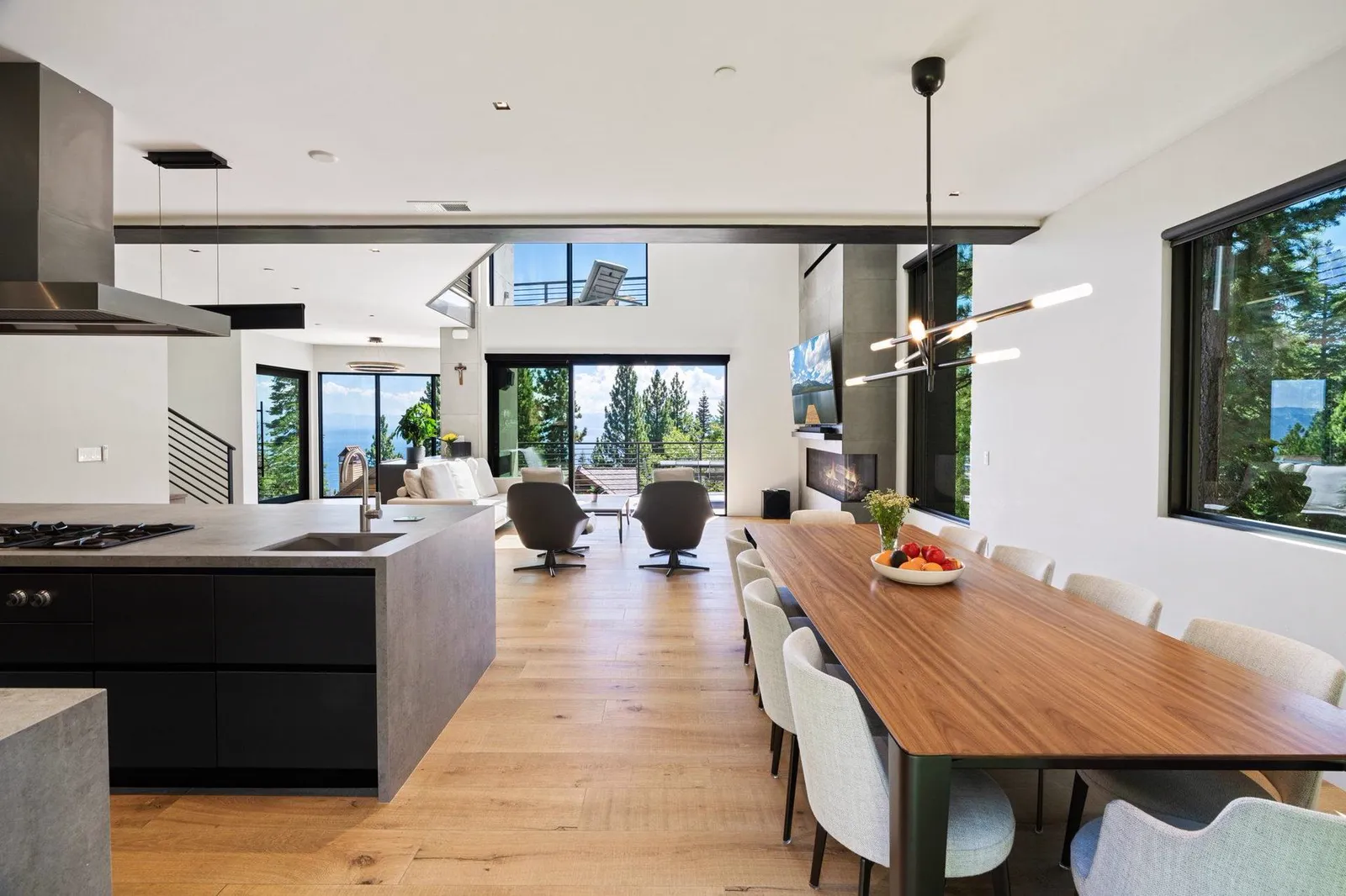 Kitchen and dining area with a long wood table and lake views