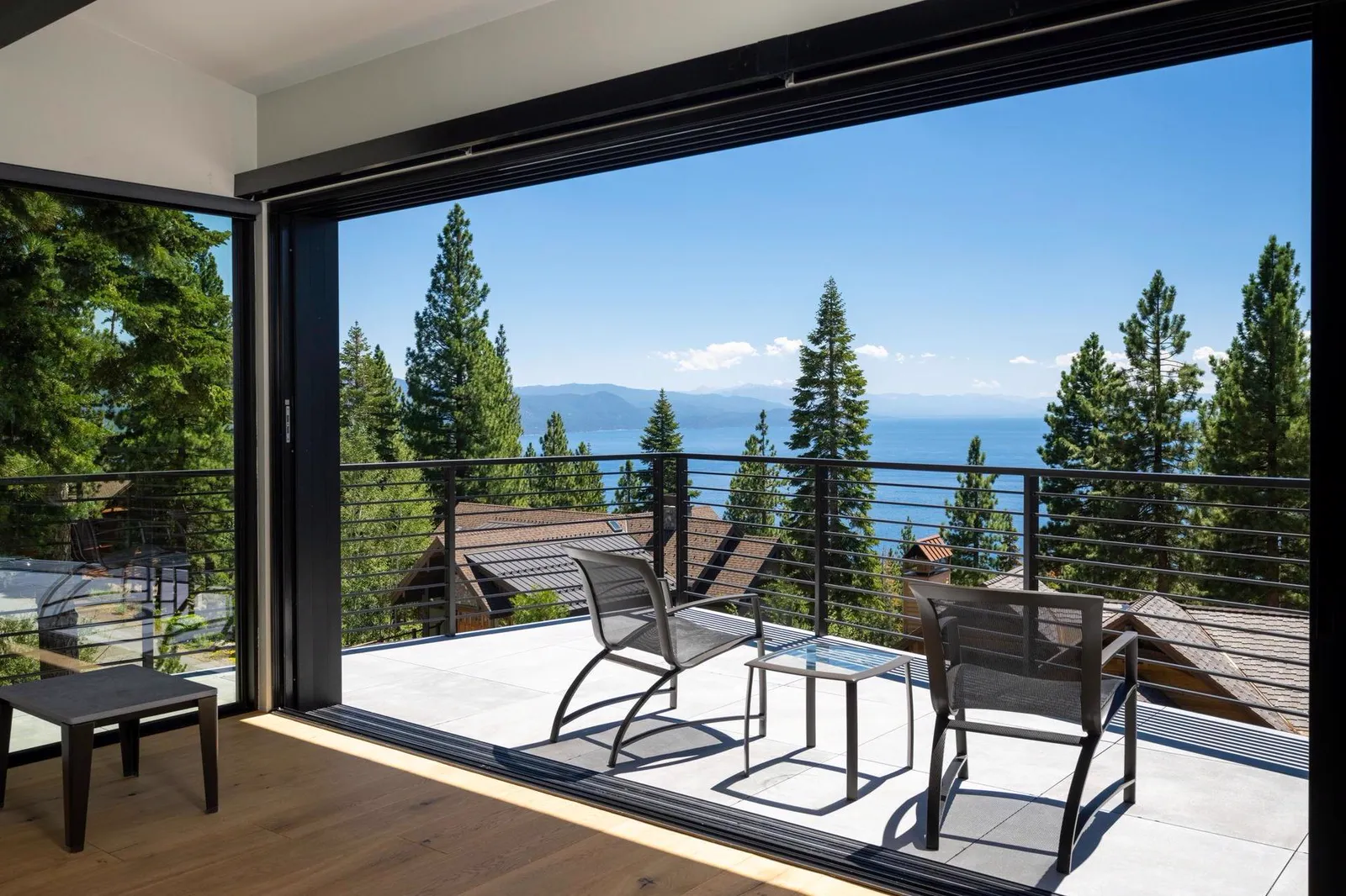 Large opening from a bedroom to the deck with a lake view