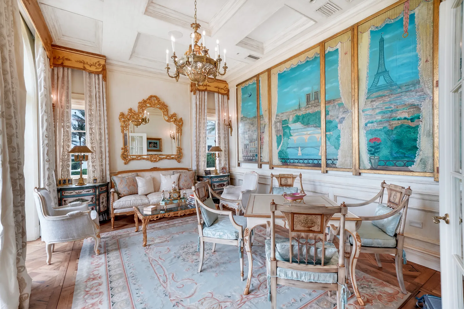 Breakfast room with ocean murals, a gilded mirror, and a round table