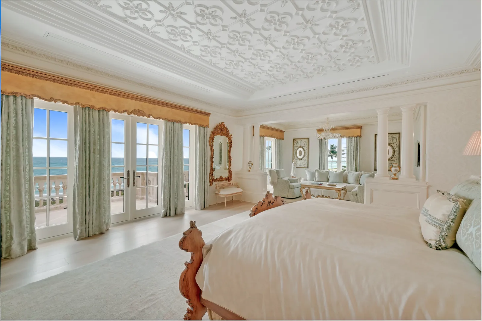 Primary bedroom with ocean views through French doors