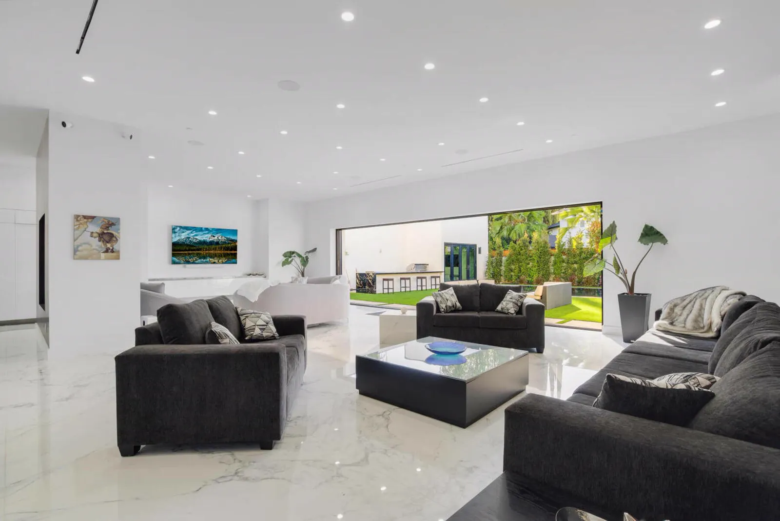 Living room seating with dark sofas and a glass coffee table