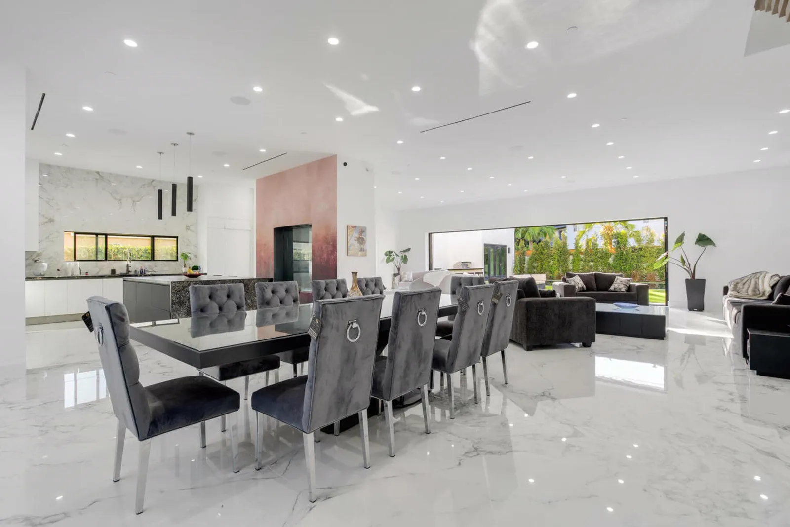 Dining room with gray upholstered chairs for ten