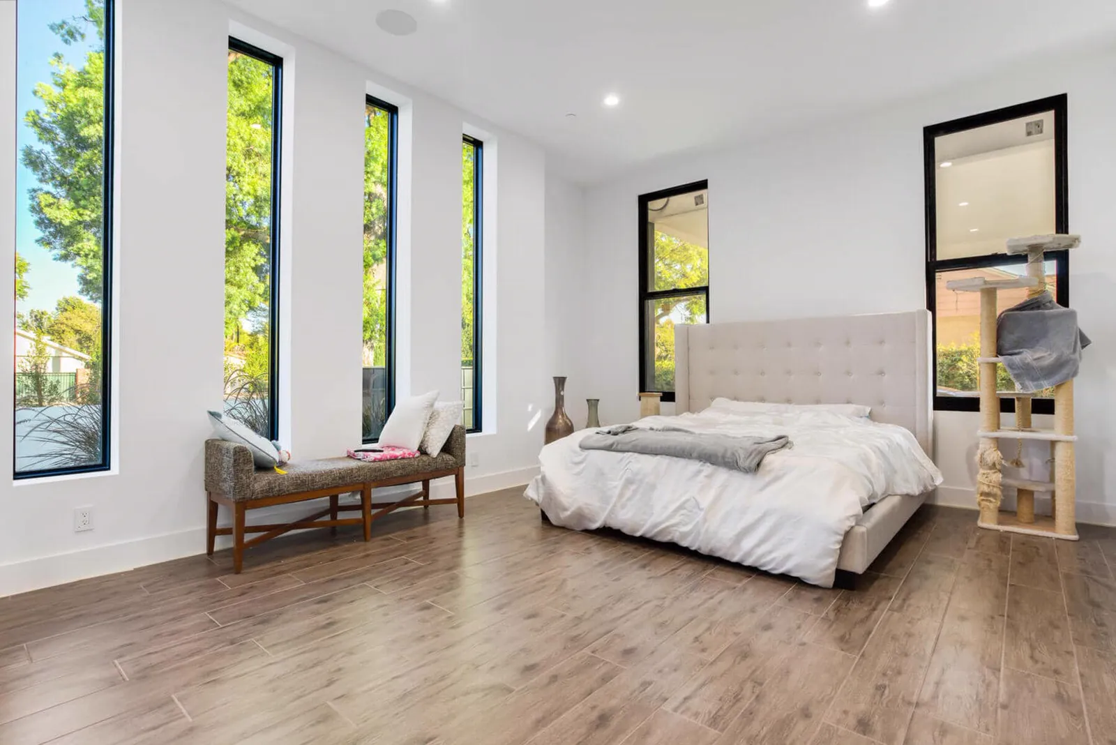 Bedroom with wood floors and tall narrow windows