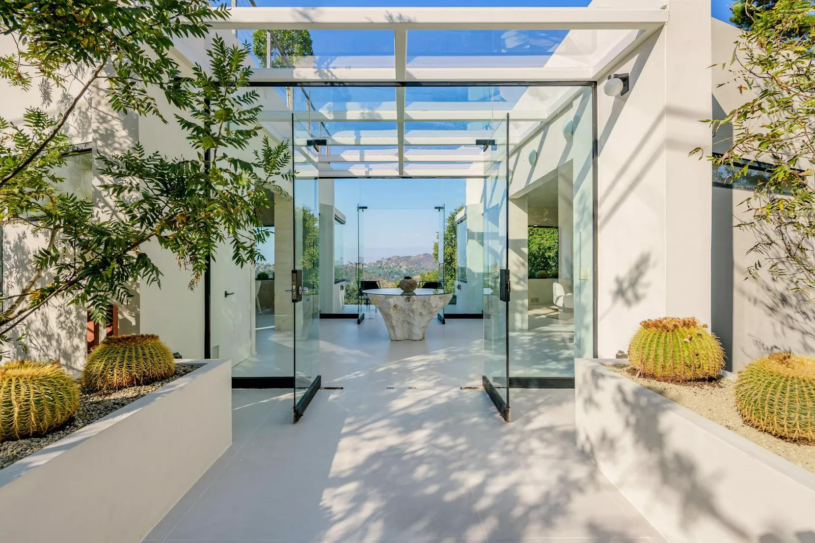 Glass-roofed entry atrium with cactus planters