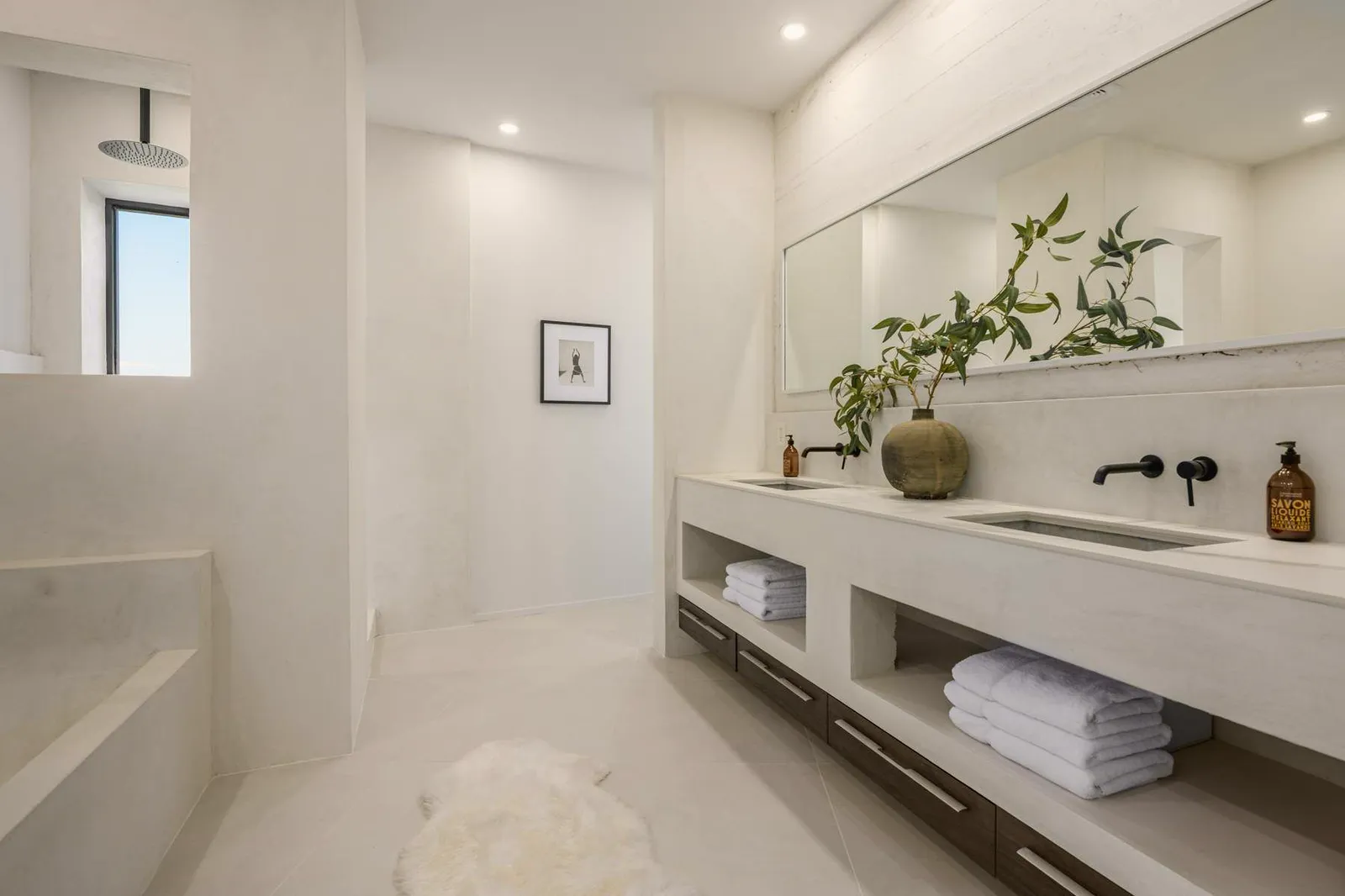 Bathroom with a long floating vanity and open shelves