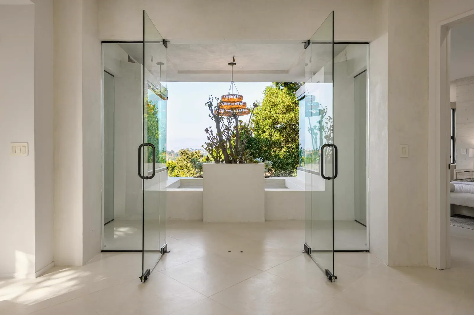 Bathroom with a freestanding tub between two glass shower enclosures