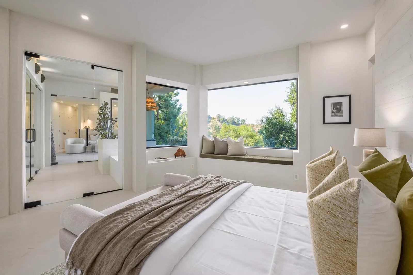 Primary bedroom with a window seat and hillside views