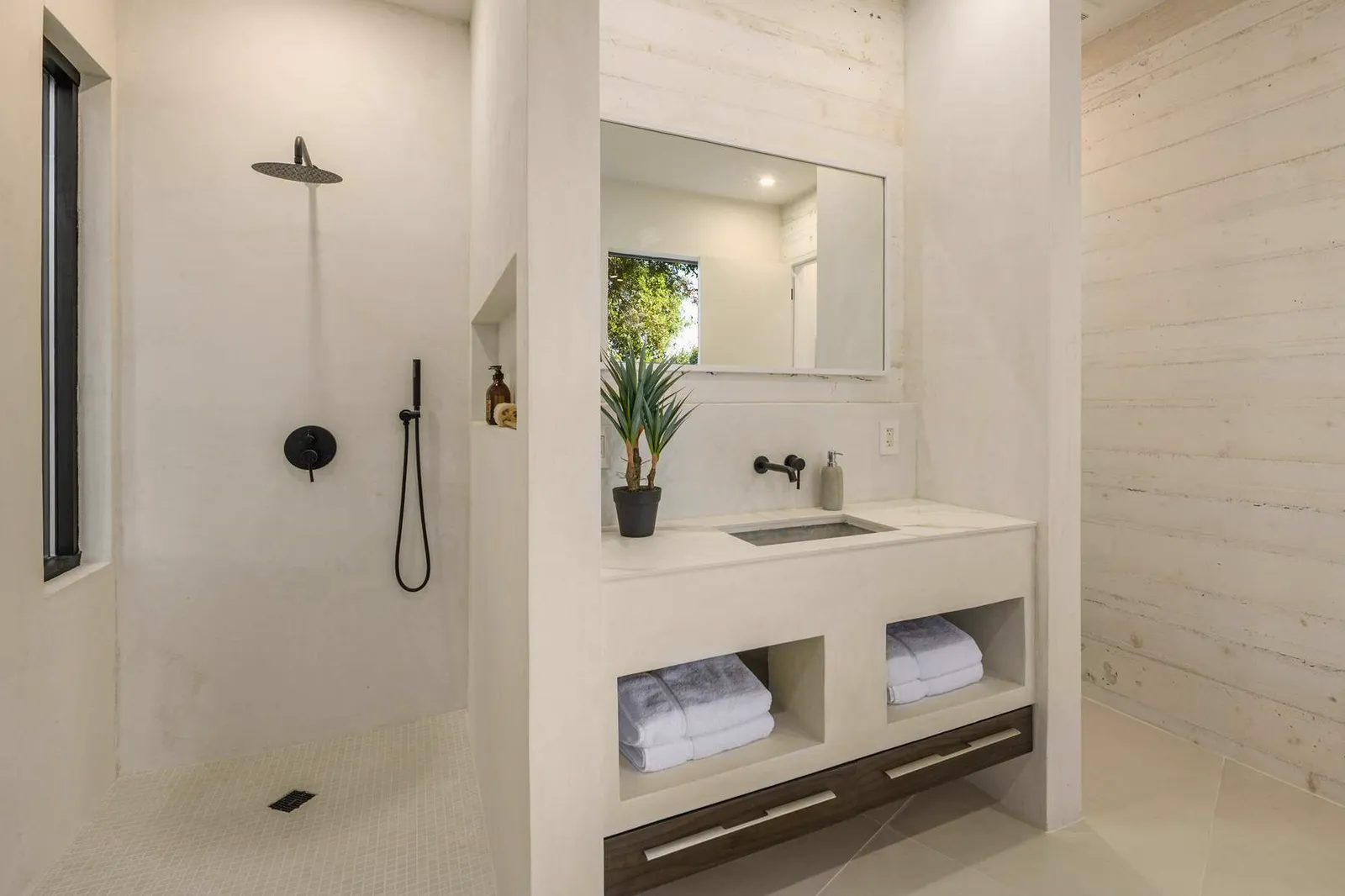 Shower and vanity with open towel shelves