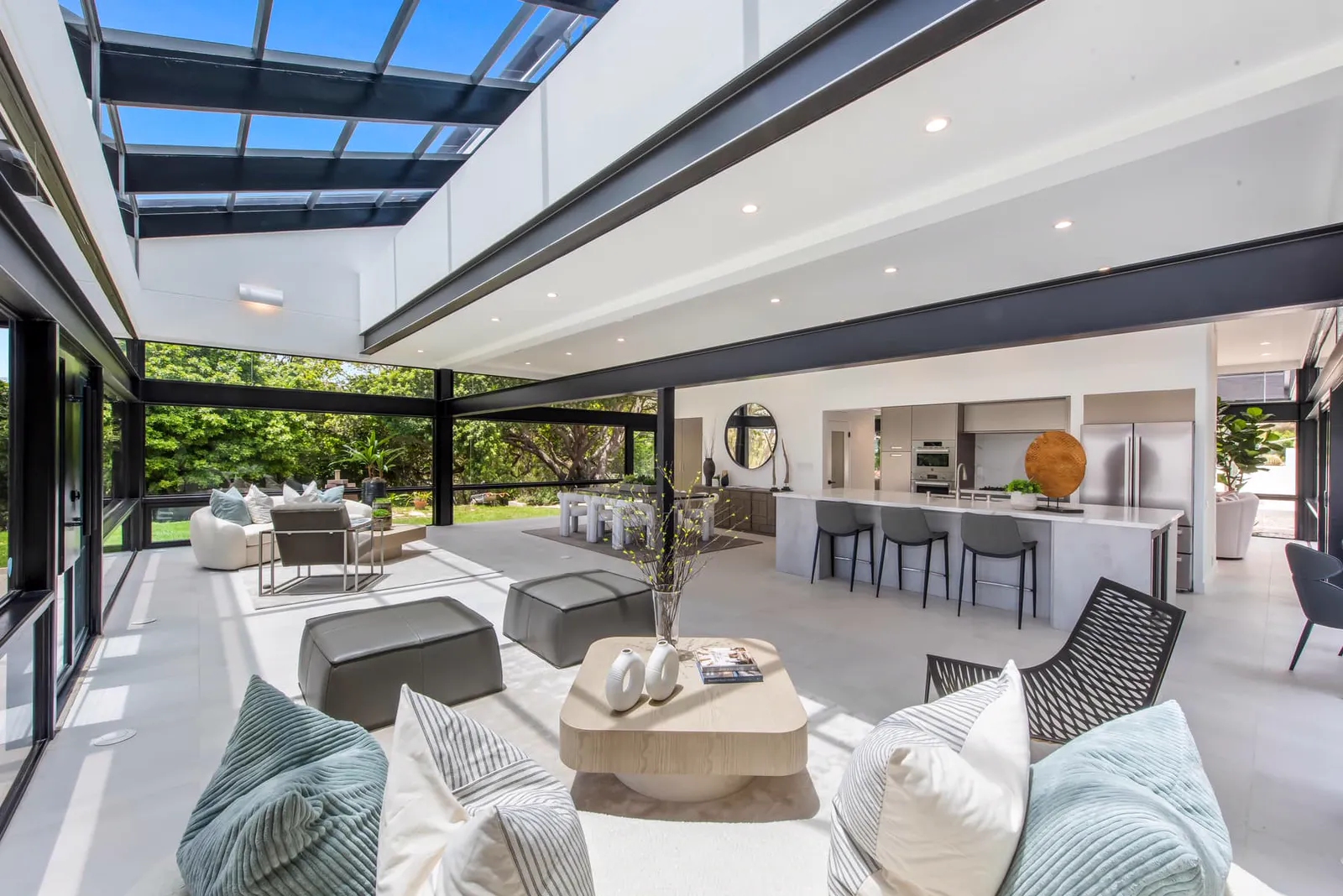 Living room under a glass roof with views to the kitchen