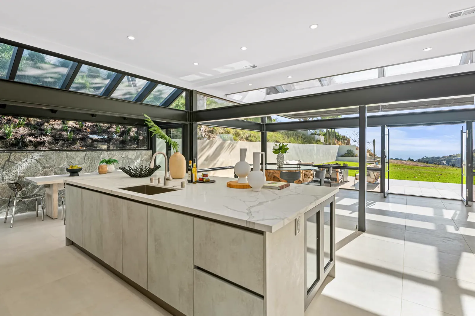 Kitchen island with a stone wall and glass roof
