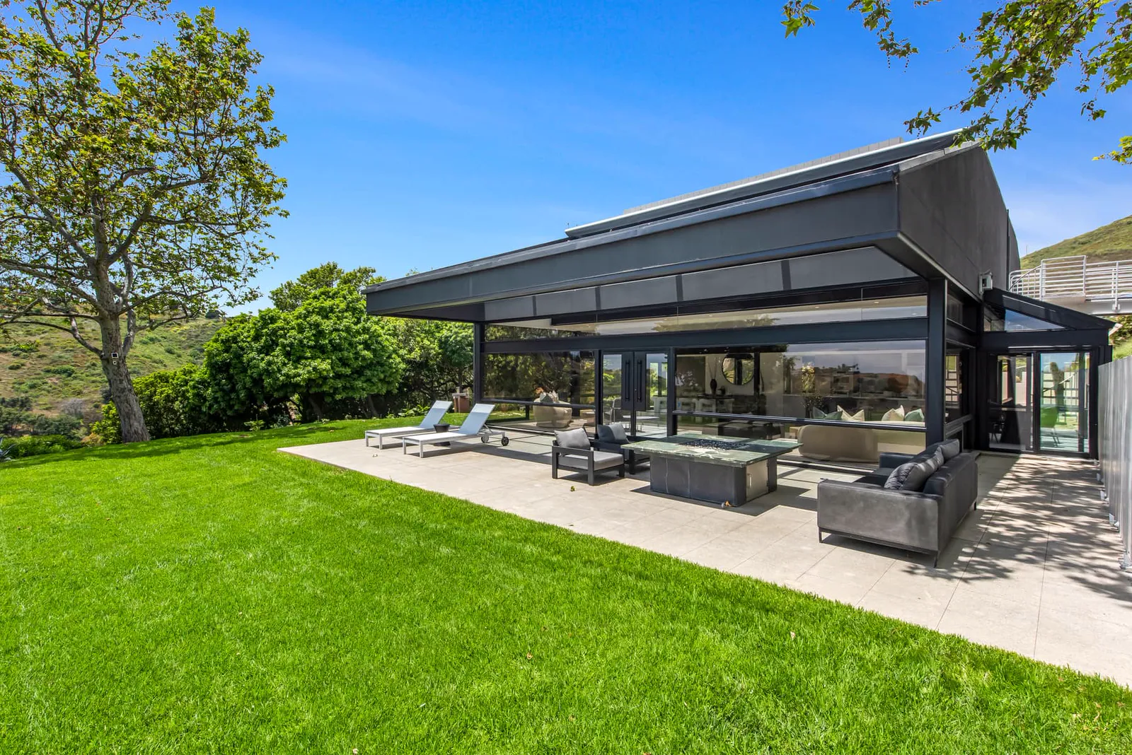 Lawn and covered terrace at the back of the house