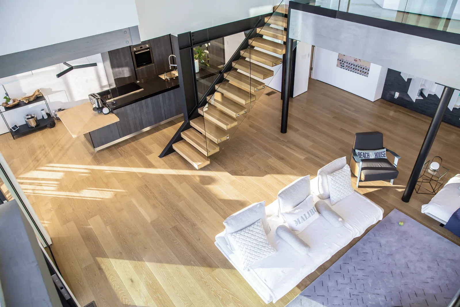 View from above of a floating oak stair and the living room