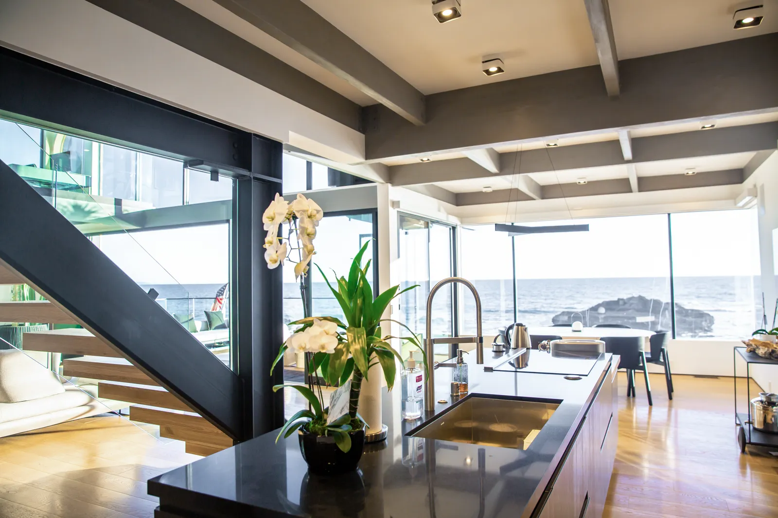 Kitchen counter with a dark stone top and the ocean beyond