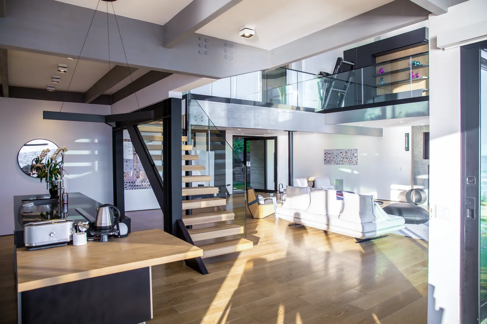 Kitchen island with a wood counter extension and the stair beyond