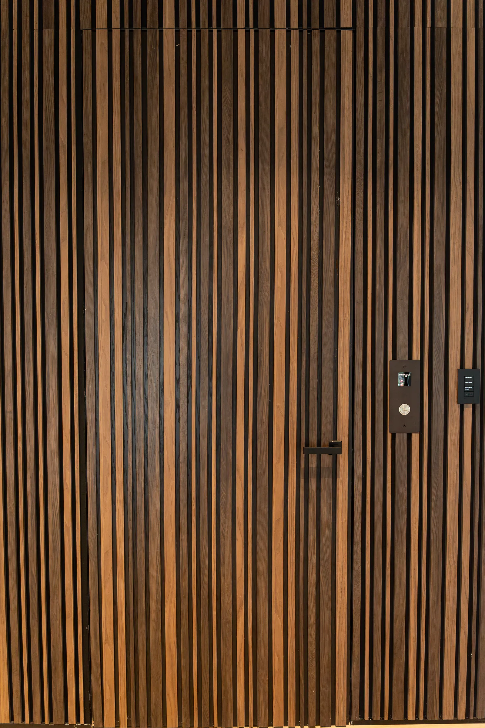 Wood slat wall with a concealed door