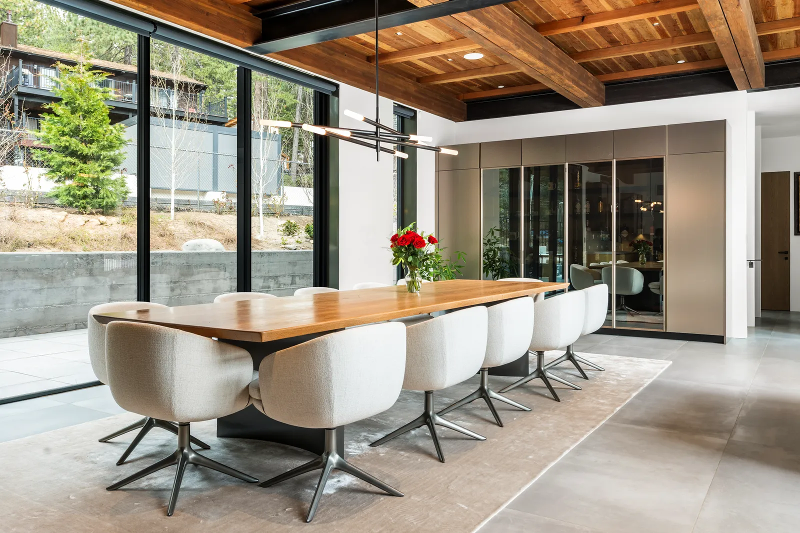 Dining table for ten beside floor-to-ceiling windows
