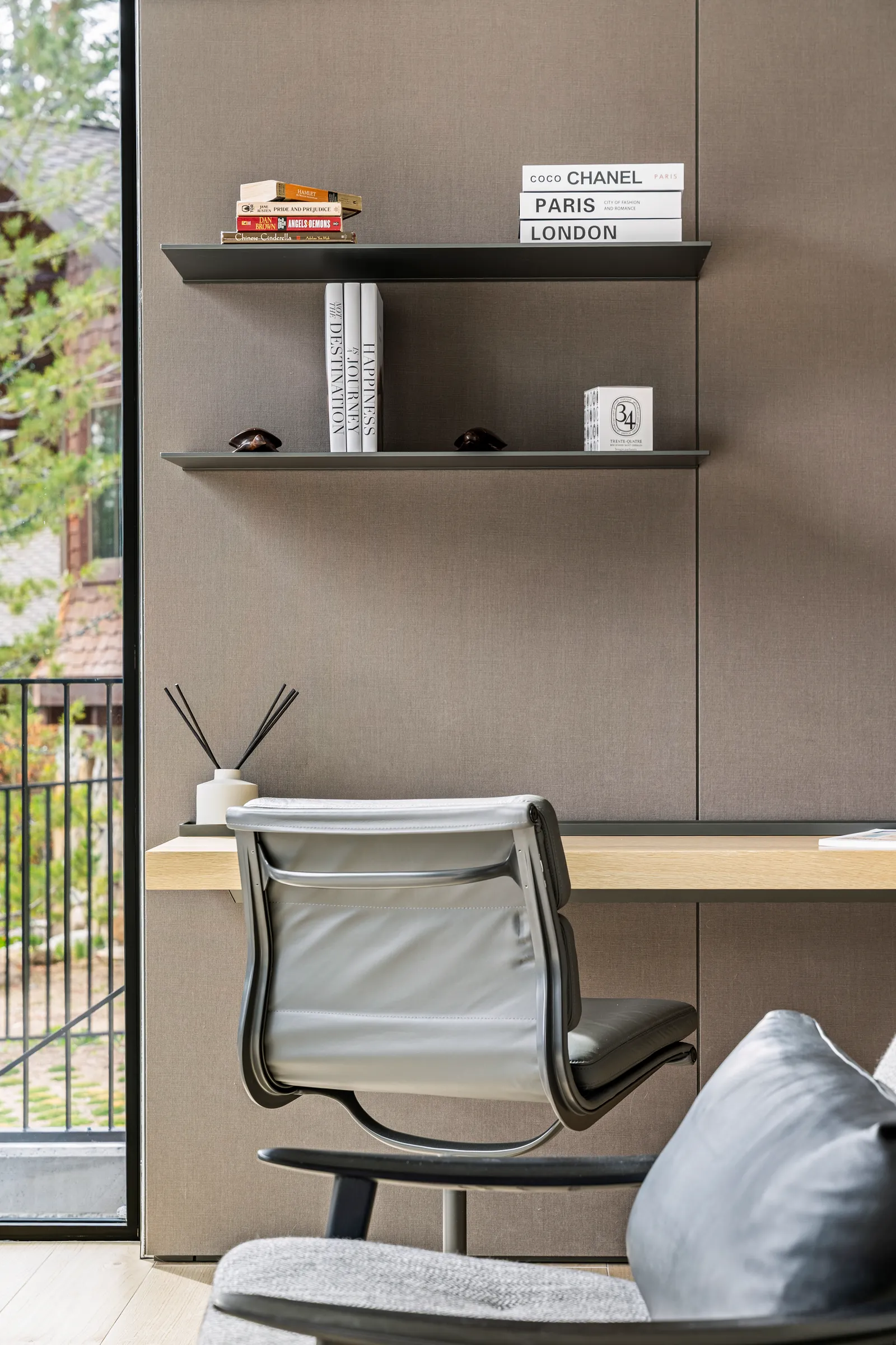 Office corner with floating shelves and a mesh chair