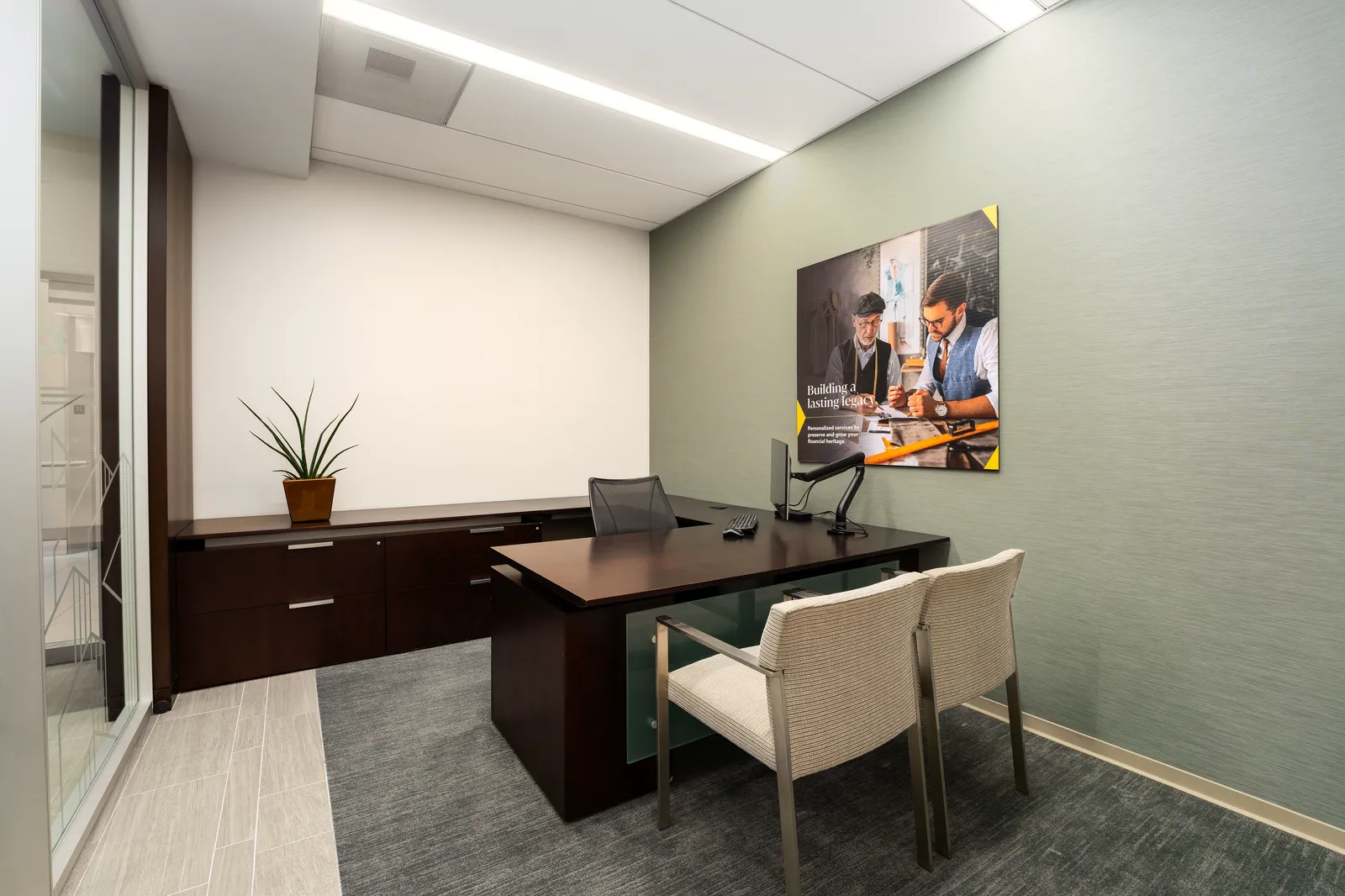 Private office with a desk and a green-gray wall