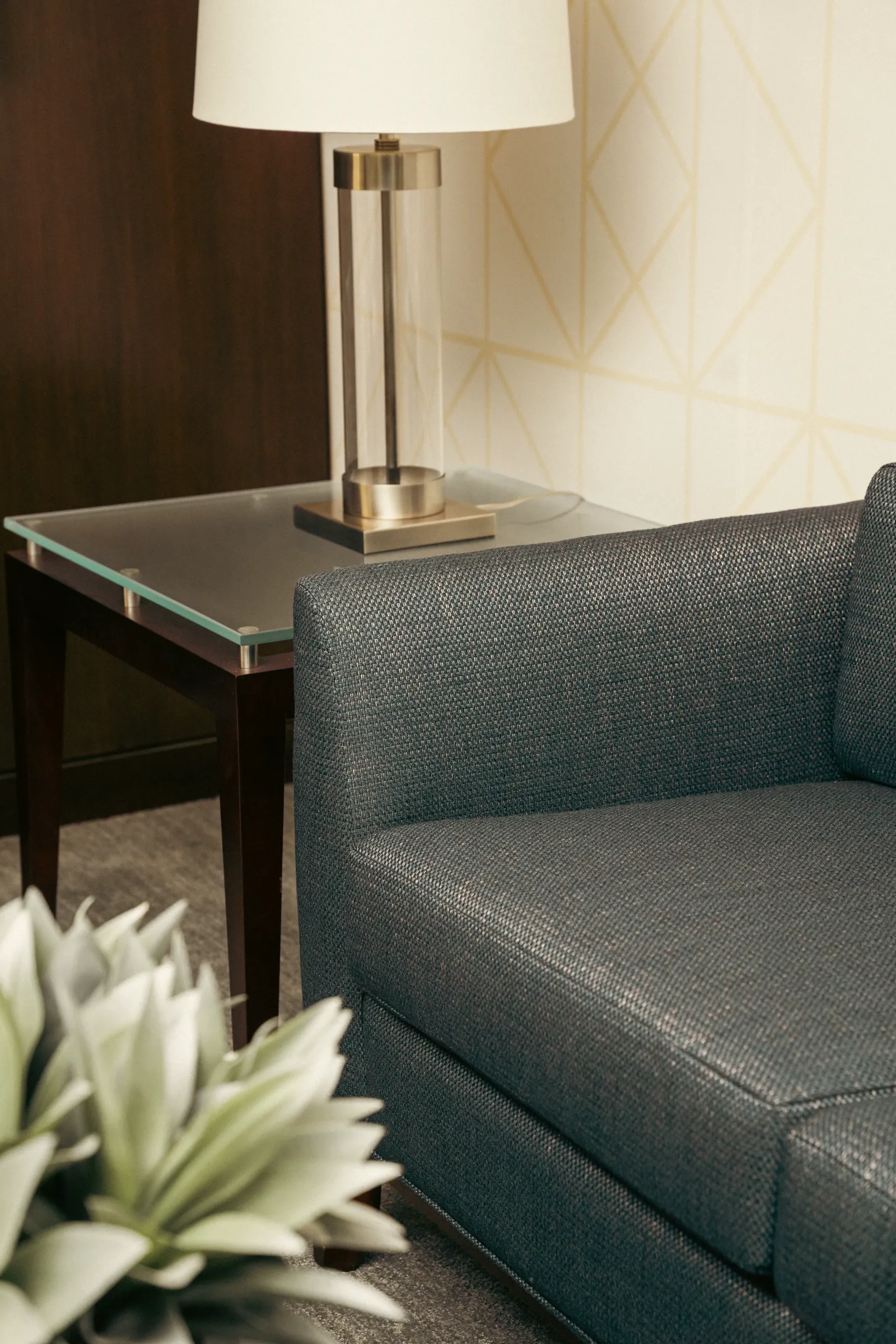 Navy leather sofa beside a lamp table