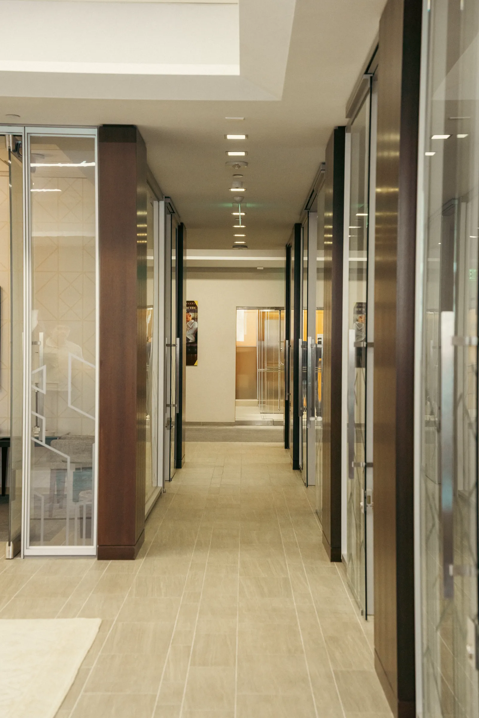 Corridor lined with glass-front offices
