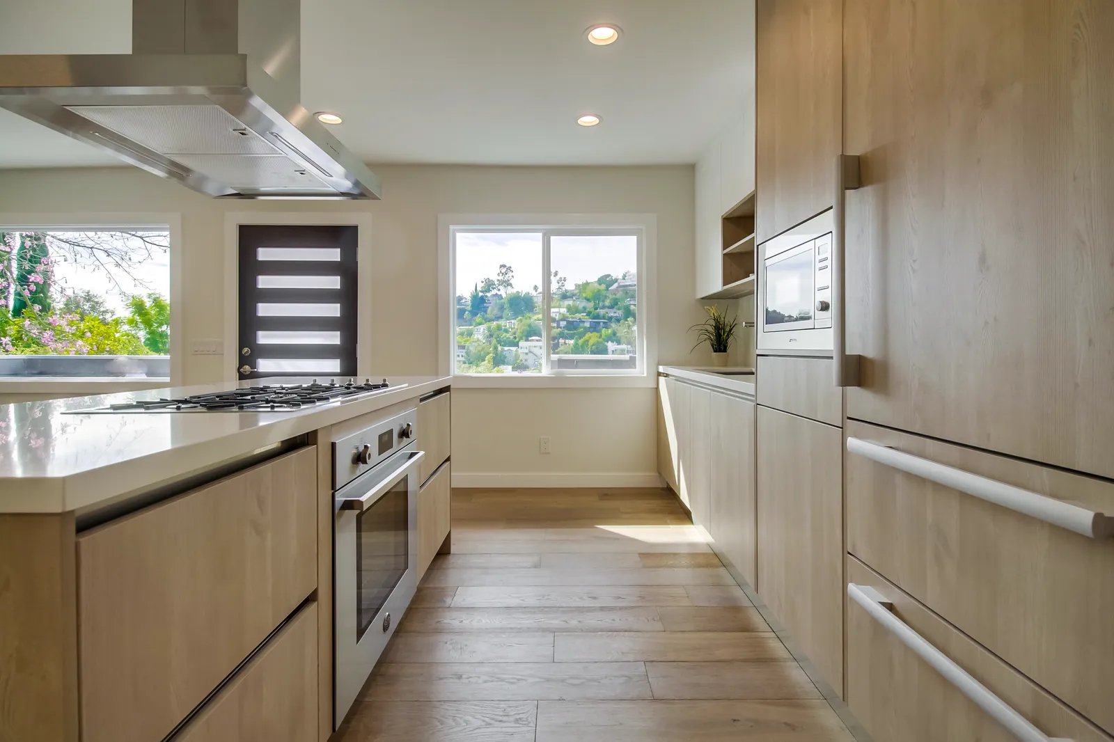 Kitchen with full-height oak cabinets and the entry door beyond